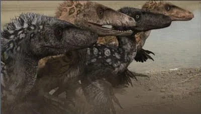 Still from Dinosaur Revolution showing a pack of feathered raptor dinosaurs charging across a beach